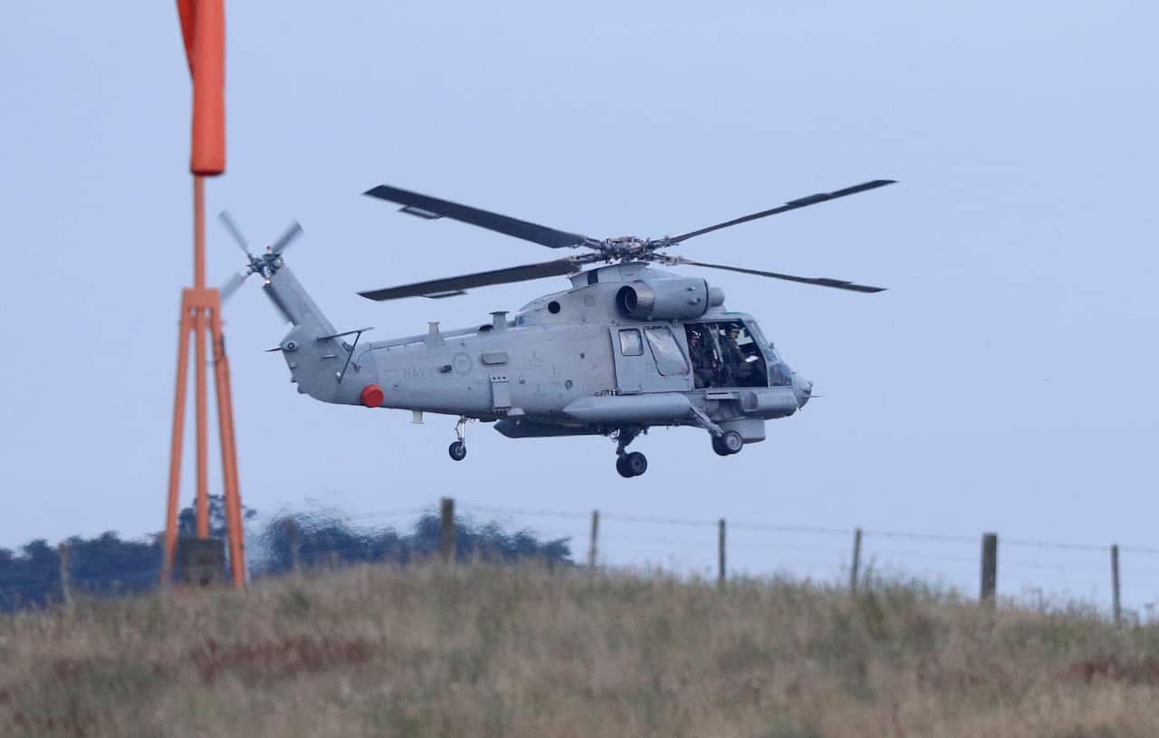 A New Zealand Navy helicopter takes off from Whakatane Airport as the mission to return victims of the White Island eruption begins in Whakatane, New Zealand.