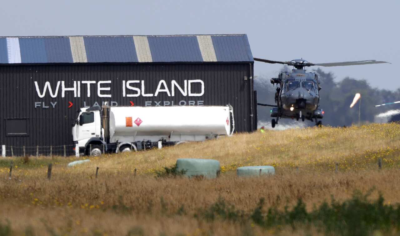 A Navy helicopter returns to Whakatane Airport following the recovery operation.