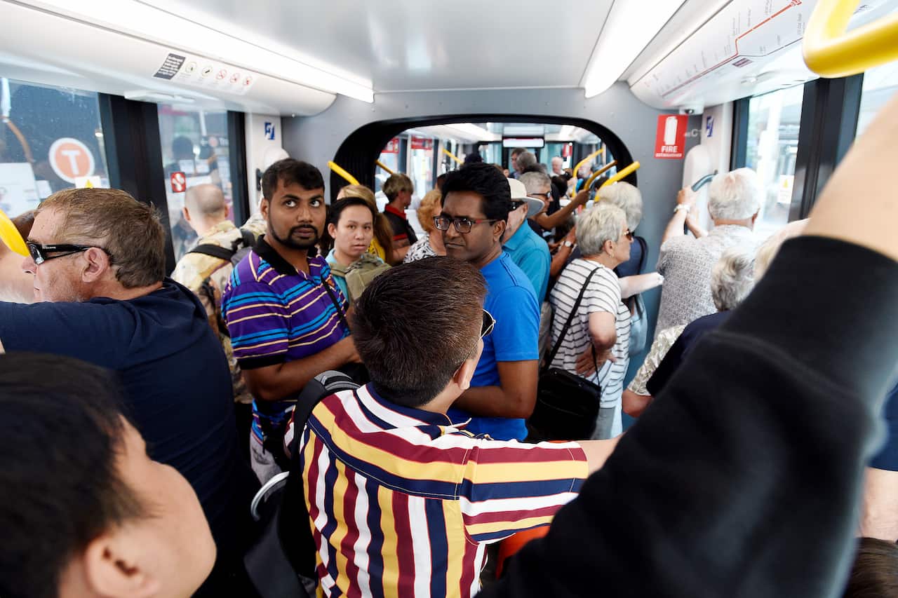 Passengers are seen onboard the new light rail after it was officially opened to the public at Circular Quay in Sydney, Saturday, December 14, 2019. (AAP Image/Bianca De Marchi) NO ARCHIVING