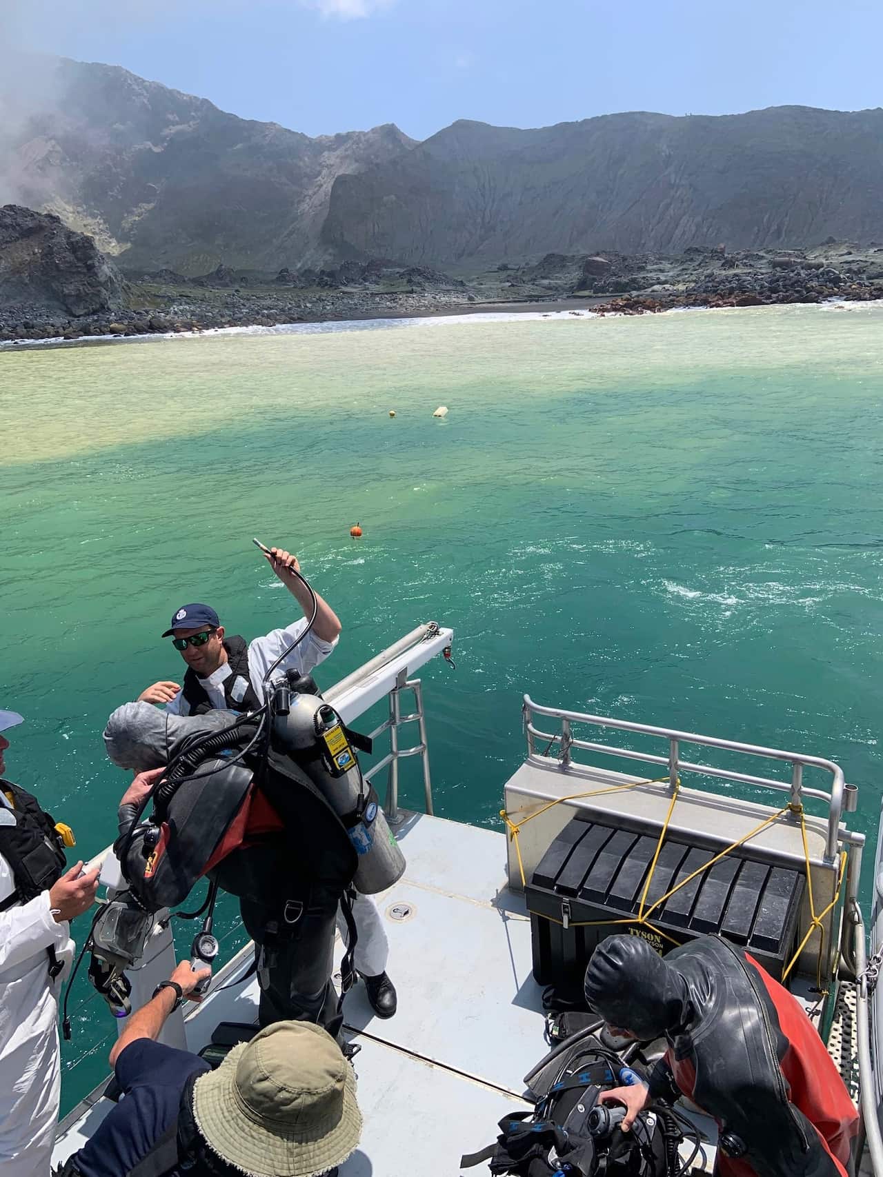 Police divers prepare to search the waters near White Island off the coast of Whakatane, New Zealand.