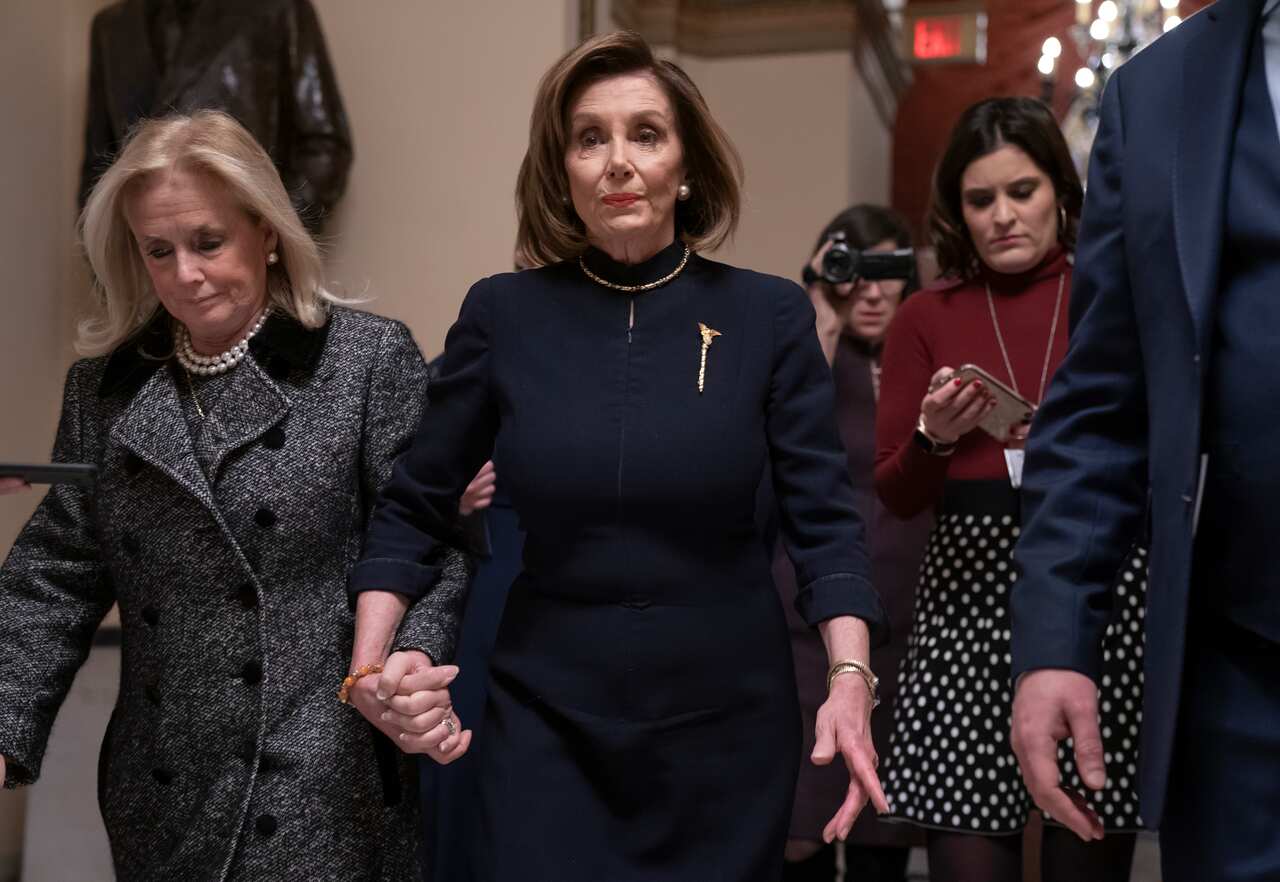 Speaker of the House Nancy Pelosi walks into the chamber where the Democrat-controlled House of Representatives just voted to impeach President Donald Trump.
