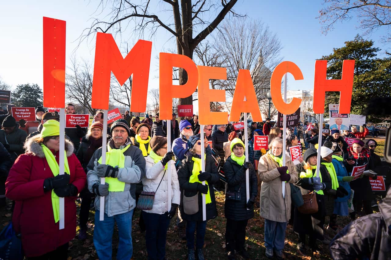 Activists gather at a 'Impeach and Remove' rally to show support for the Congressional impeachment of US President Donald Trump.