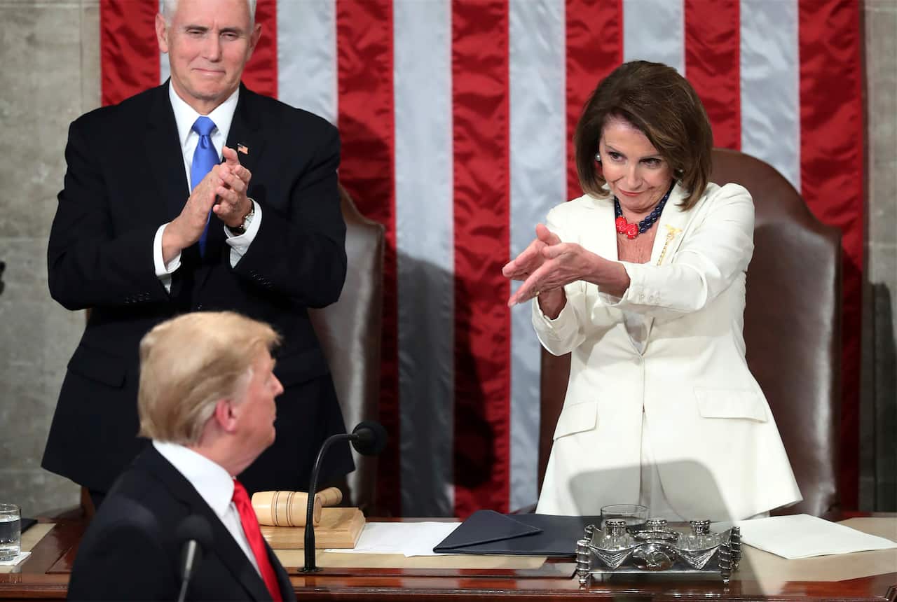 US President Donald Trump turns to House Speaker Nancy Pelosi as he delivers his State of the Union address.