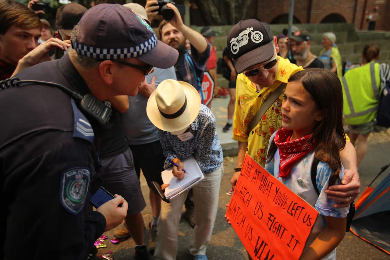  Izzy Raj-Seppings reacts after police threaten to arrest her and other protesters during a protest outside of Kirribilli House in Sydney, 19 December, 2019.