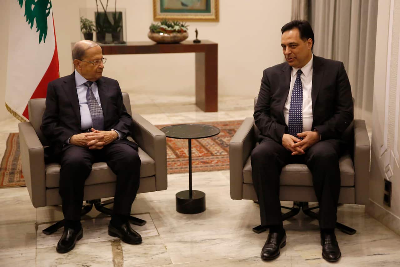 Lebanese President Michel Aoun, left, meets with Lebanese newly-assigned Prime Minister, Hassan Diab, right.