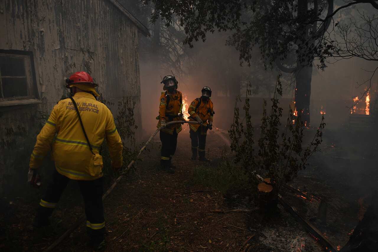 NSW Rural Fire Service crews fight the Gospers Mountain Fire as it impacts property at Bilpin.