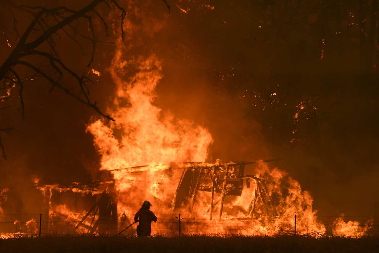 NSW Rural Fire Service crews fight the Gospers Mountain Fire as it impacts a structure at Bilpin.