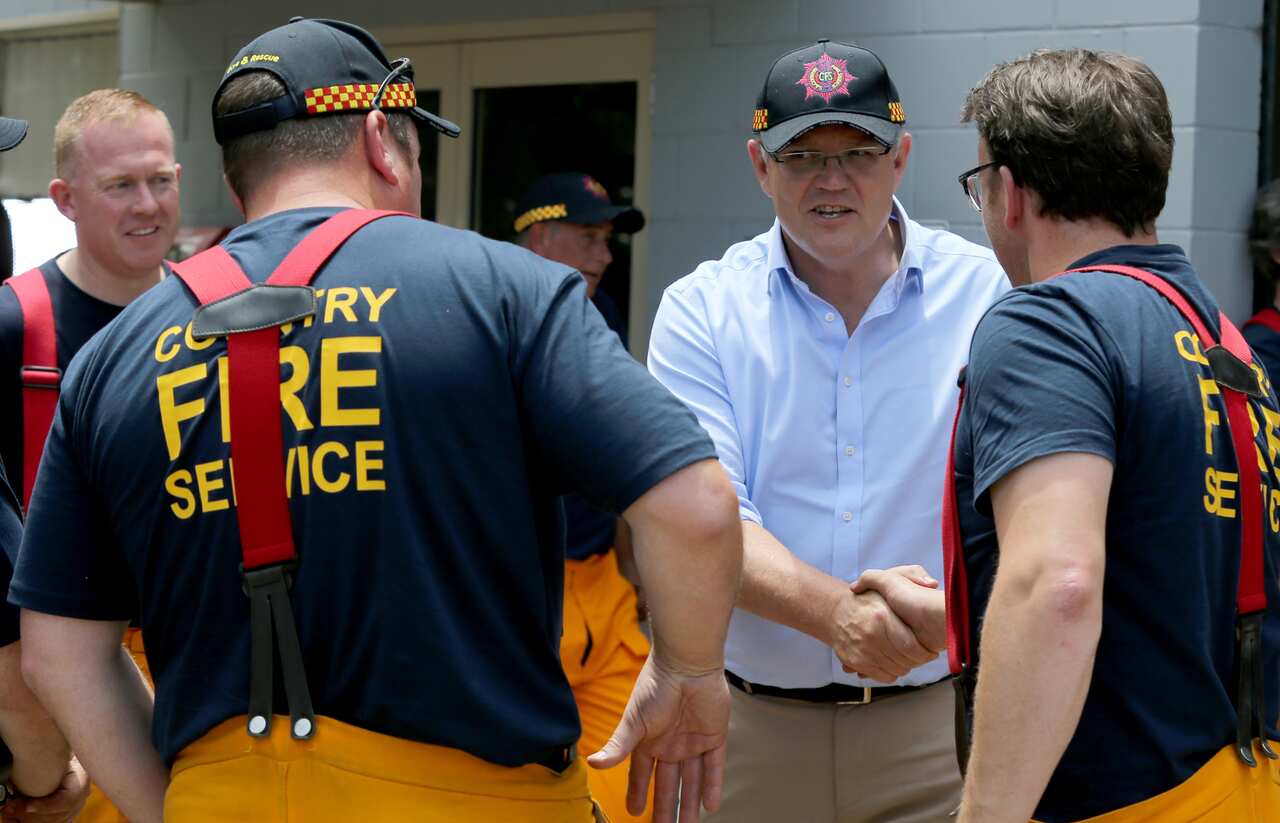 Prime Minister Scott Morrison meets crews from Woodside CFS in Woodside, Tuesday, December 24, 2019. The Prime Minister is touring fire affected areas in South Australia. (AAP Image/Kelly Barnes) NO ARCHIVING