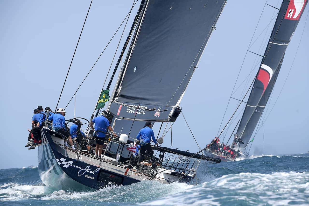 Black Jack and Scallywag (right) leave the heads at the start of the Sydney to Hobart Yacht race in Sydney, Thursday, December 26, 2019. (AAP Image/Dan Himbrechts) NO ARCHIVING, EDITORIAL USE ONLY