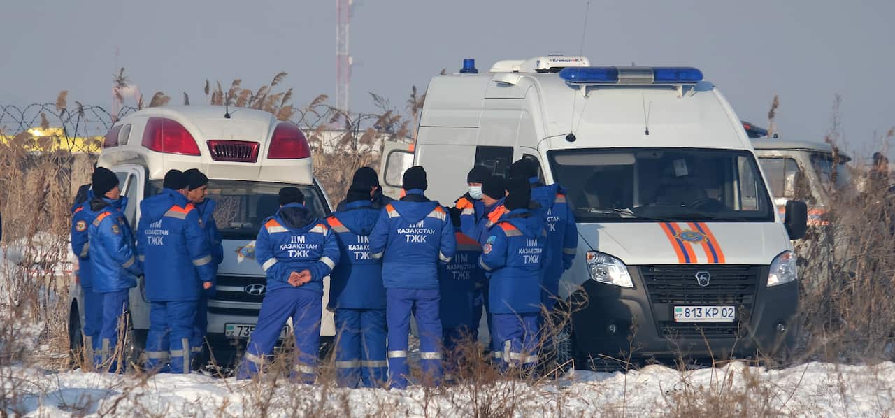 Rescuers work at the site of an airplane crash near Almaty airport, some 20 kilometres from the city of Almaty, Kazakhstan.