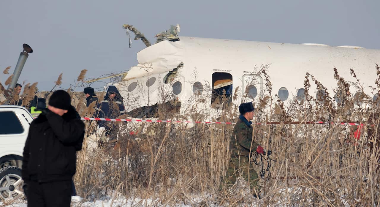 Rescuers work at the site of an airplane crash near Almaty airport.