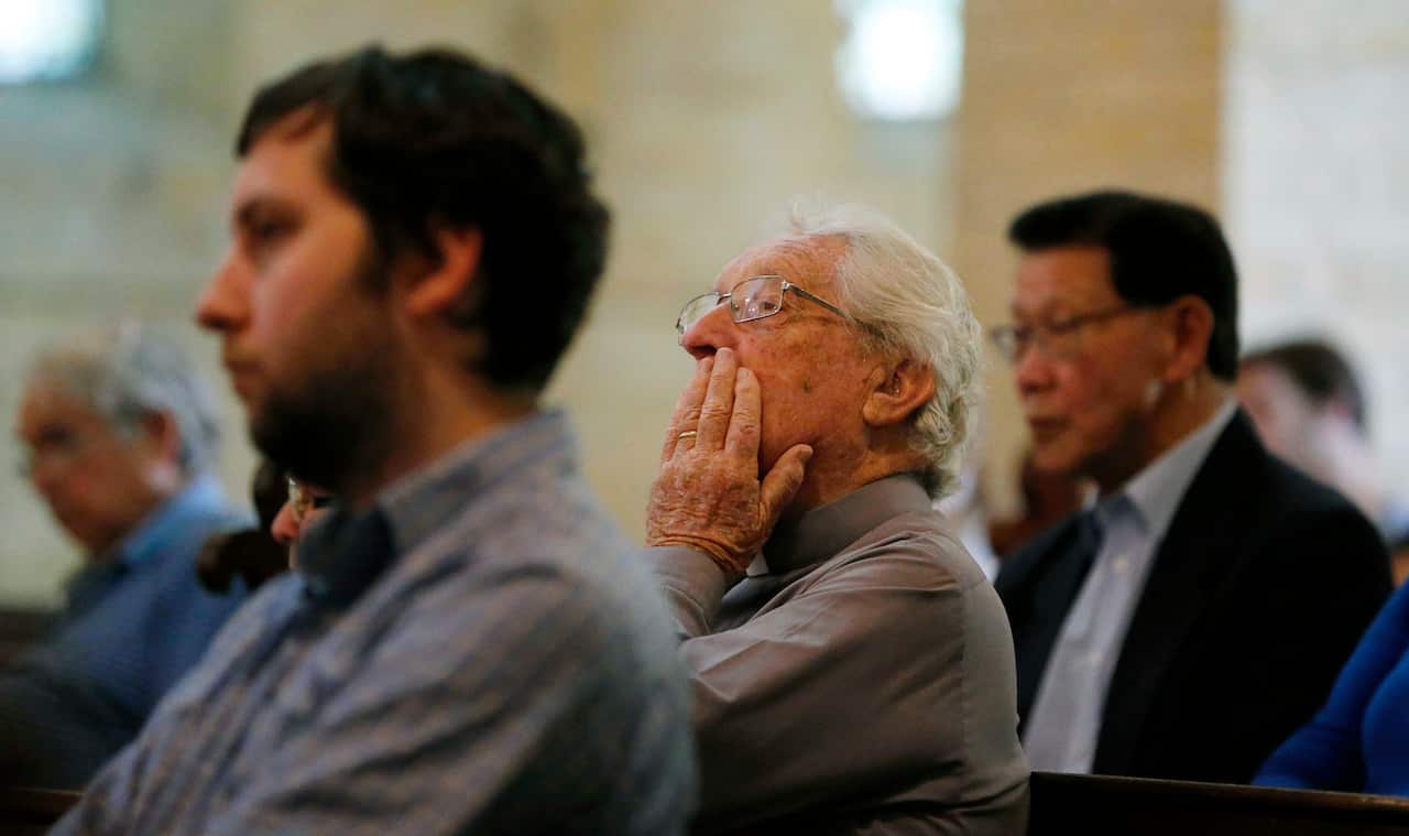 A man listens during a service to commemorate the 13 victims who died in the 1989 earthquake.