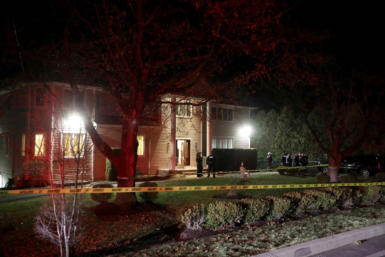 Police work at the home of a rabbi on after a man entered the house and stabbed multiple people.