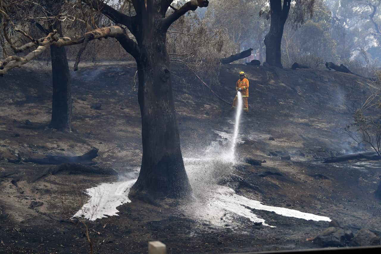 CFA firefighters are seen after a fire impacted Clovemont Way, Bundoora in Melbourne.