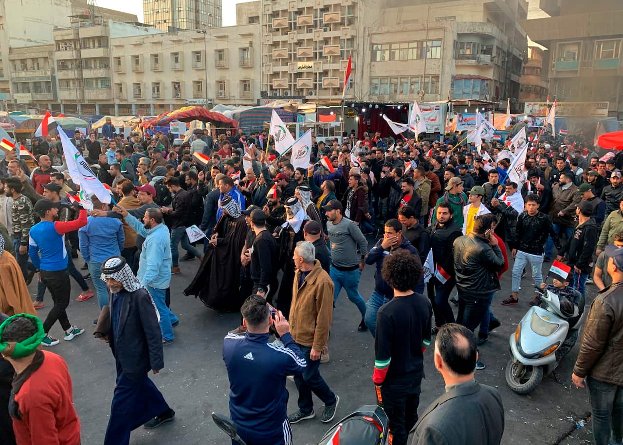 Protesters chant slogans against the US during a protest after the US strikes on the Hezbollah Brigades militia.
