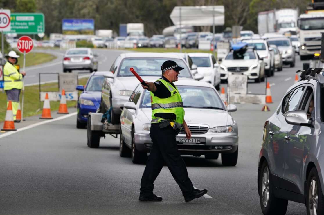 Motorists are seen approaching a checkpoint at Coolangatta on the Queensland- New South Wales border, Friday, August 7, 2020