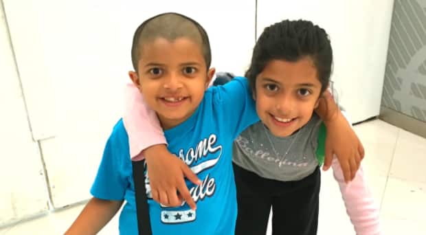 Deyaan Udani (left) with his older sister before he died.