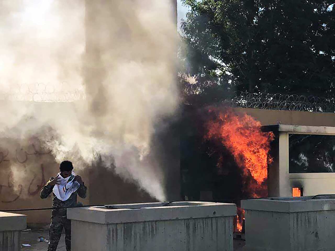 Iraqi Shiite protesters try to storm the US Embassy in Baghdad.