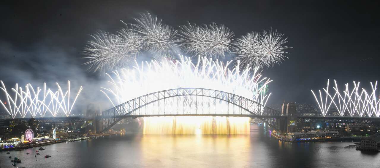 The Midnight fireworks explode over the Sydney Harbour Bridge on Sydney Harbour during the Year's Eve celebrations in Sydney, Tuesday, December 31, 2019. (AAP Image for City of Sydney/Lukas Coch) NO ARCHIVING, EDITORIAL USE ONLY