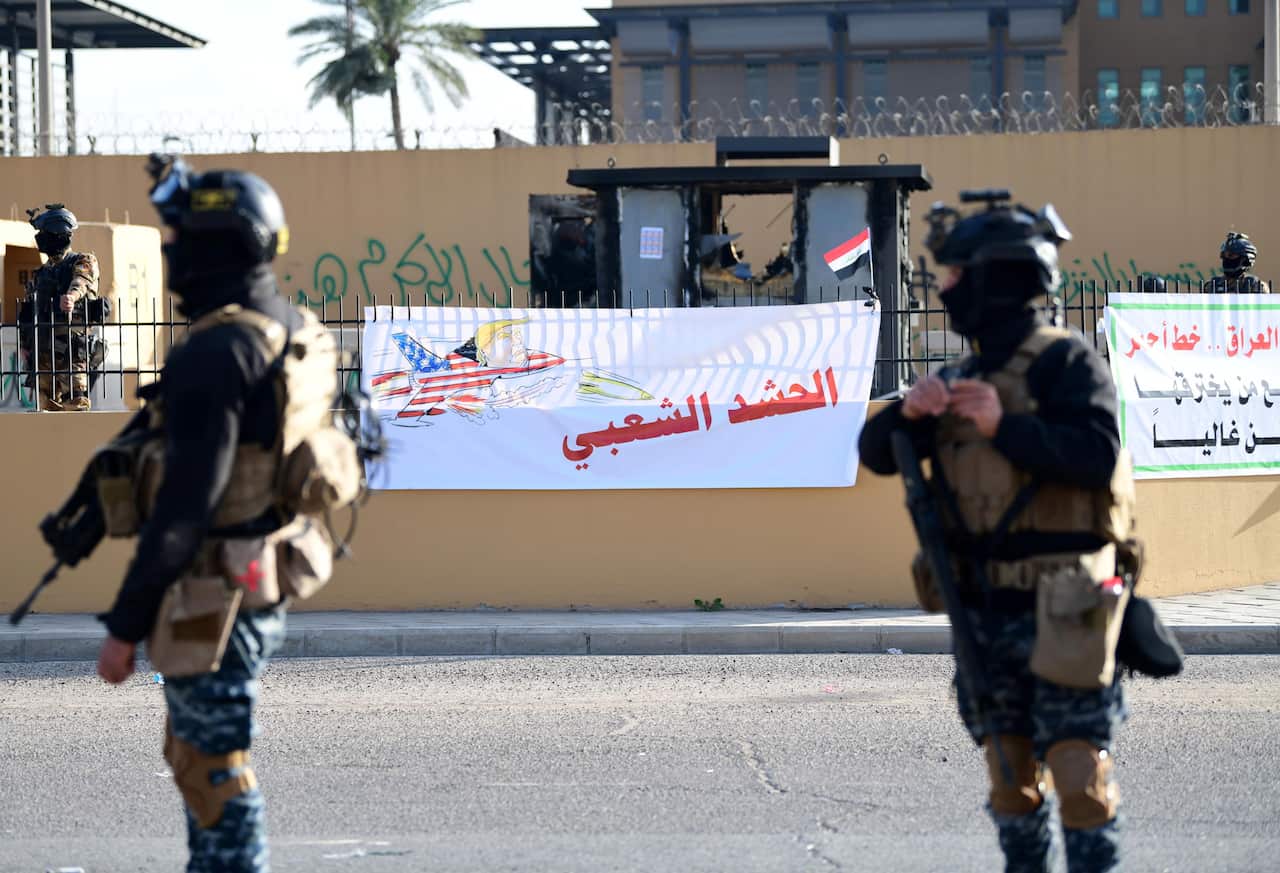 Iraqi policemen guard the front of the US Embassy in Baghdad, Iraq.