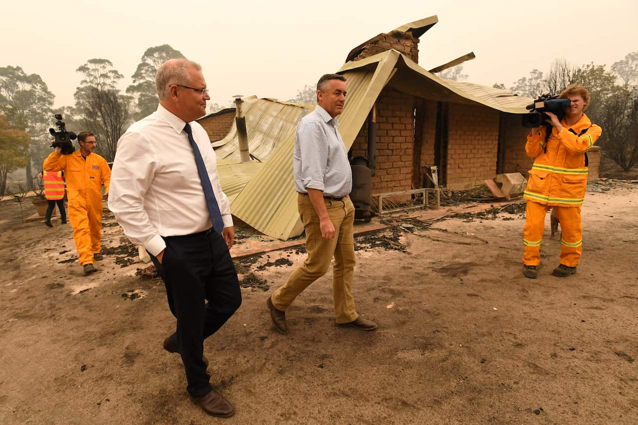 Prime Minister Scott Morrison (left) and Darren Chester MP tour the fire-ravagfed Wildflower farm owned by Paul and Melissa Churchman in Sarsfield, Victoria.