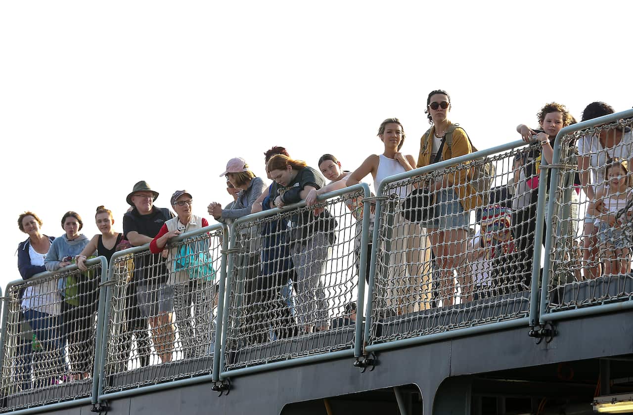 The navy ship MV Sycamore arrives at the port of Hastings with evacuees from Mallacoota.