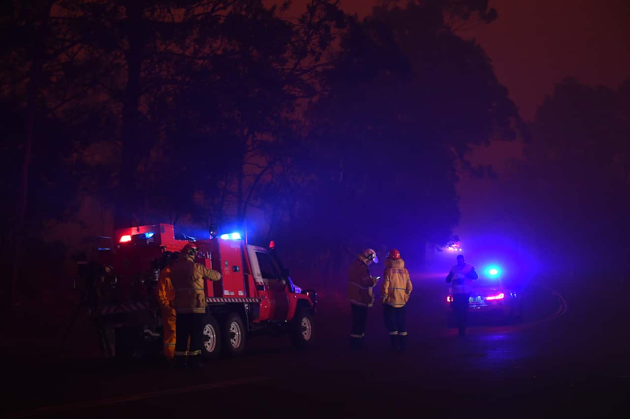 Rural Fire Service personnel at a roadblock near a bushfire in North Nowra.