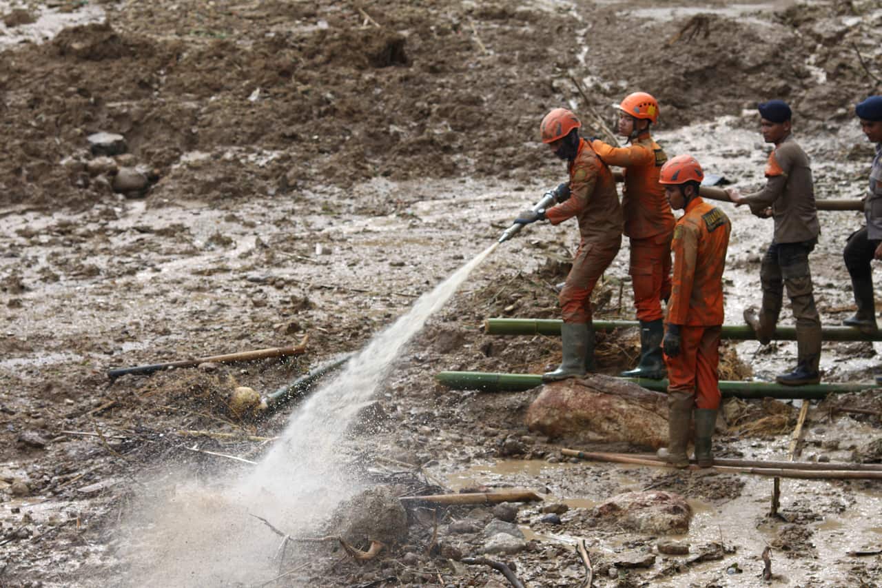Rescuers search for victims at a village affected by a landslide in Cigudeg, West Java, Indonesia.