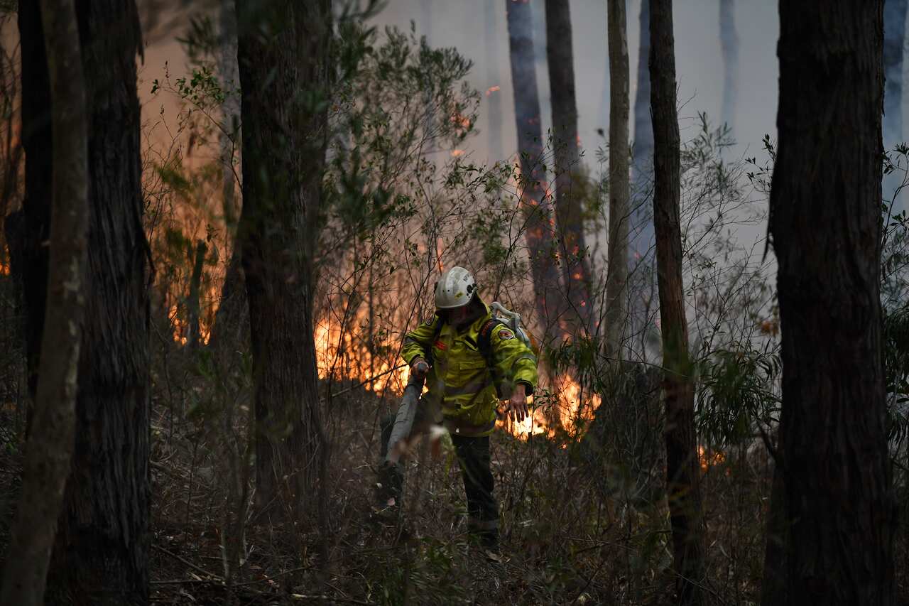 Rural Fire Service volunteers, National Parks and Wildlife Service staff and Queensland Rural Bushfire Brigade volunteers back burn south of Ulladulla, NSW.