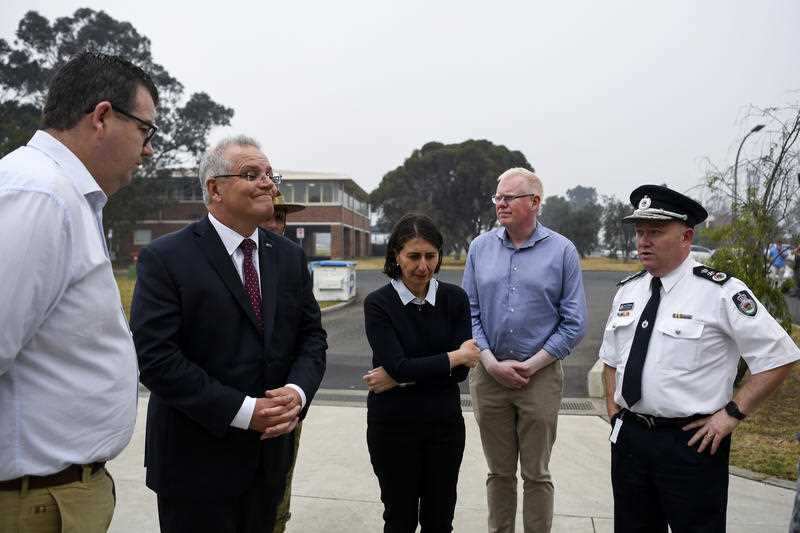 Prime Minister Scott Morrison, NSW Premier Gladys Berejiklian and NSW RFS Commissioner Shane Fitzsimmons in Nowra, Sunday, January 5, 2020.