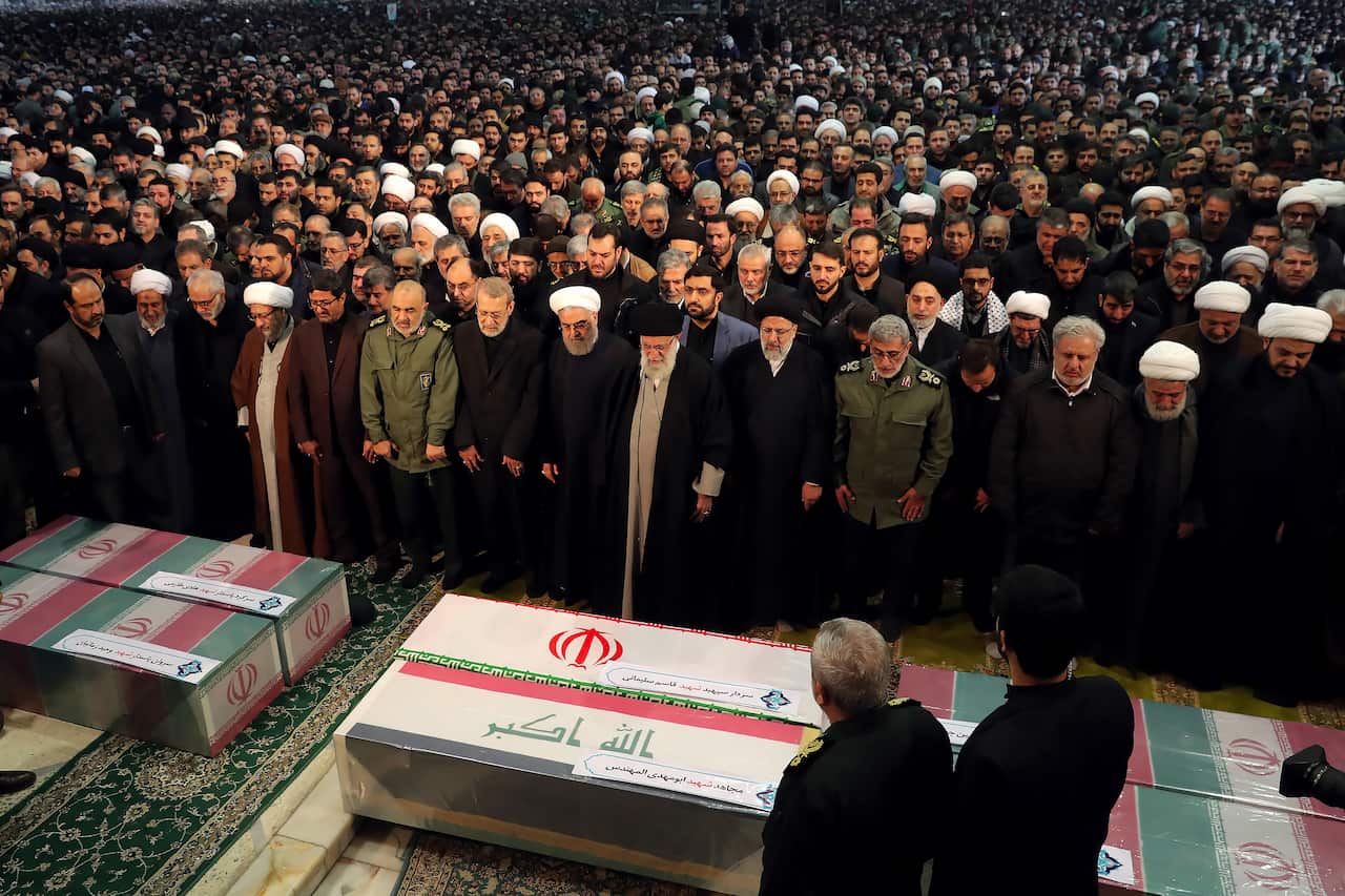 Iran's Supreme Leader (C) leading a prayer over the caskets of slain military commander Qasem Soleimani and Iraqi paramilitary chief Abu Mahdi al-Muhandis