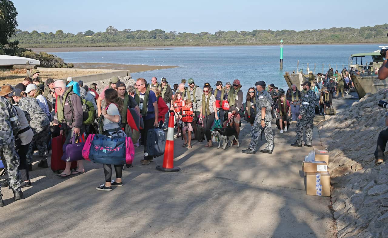 Evacuees disembarks the HMAS Choules in Hastings, Victoria.