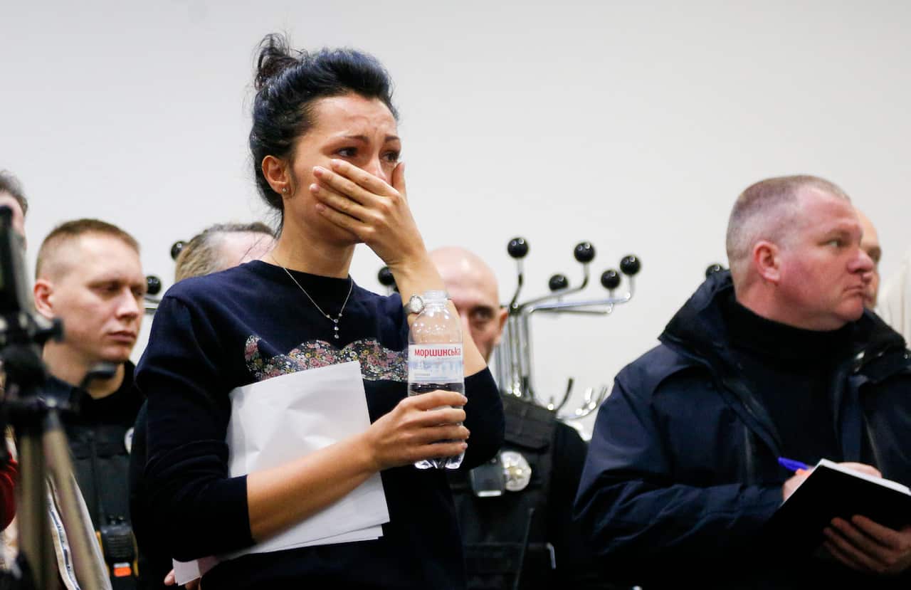 A Ukrainian International Airline company worker reacts during a briefing at Borispil international airport outside Kyiv, Ukraine.