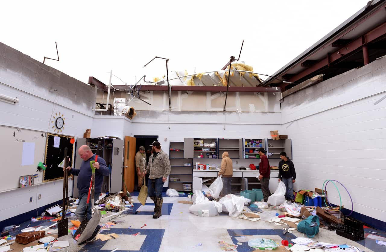 People clean up the classrooms of Benton Middle School in Benton, Louisiana.