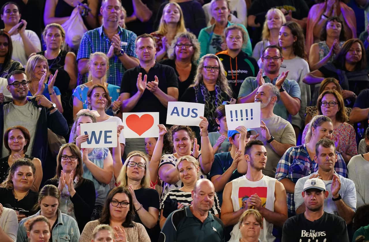 Fans in the crowd show their support during the Rally For Relief at Rod Laver Arena.