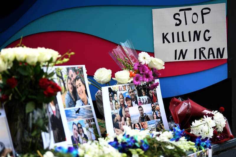 Members of the Australian Iranian community place tributes during a Sydney memorial service for the victims of the Ukraine International Airlines Flight PS752