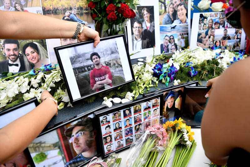 Members of the Australian Iranian community place tributes during a Sydney memorial service for the victims of the Ukraine International Airlines Flight PS752