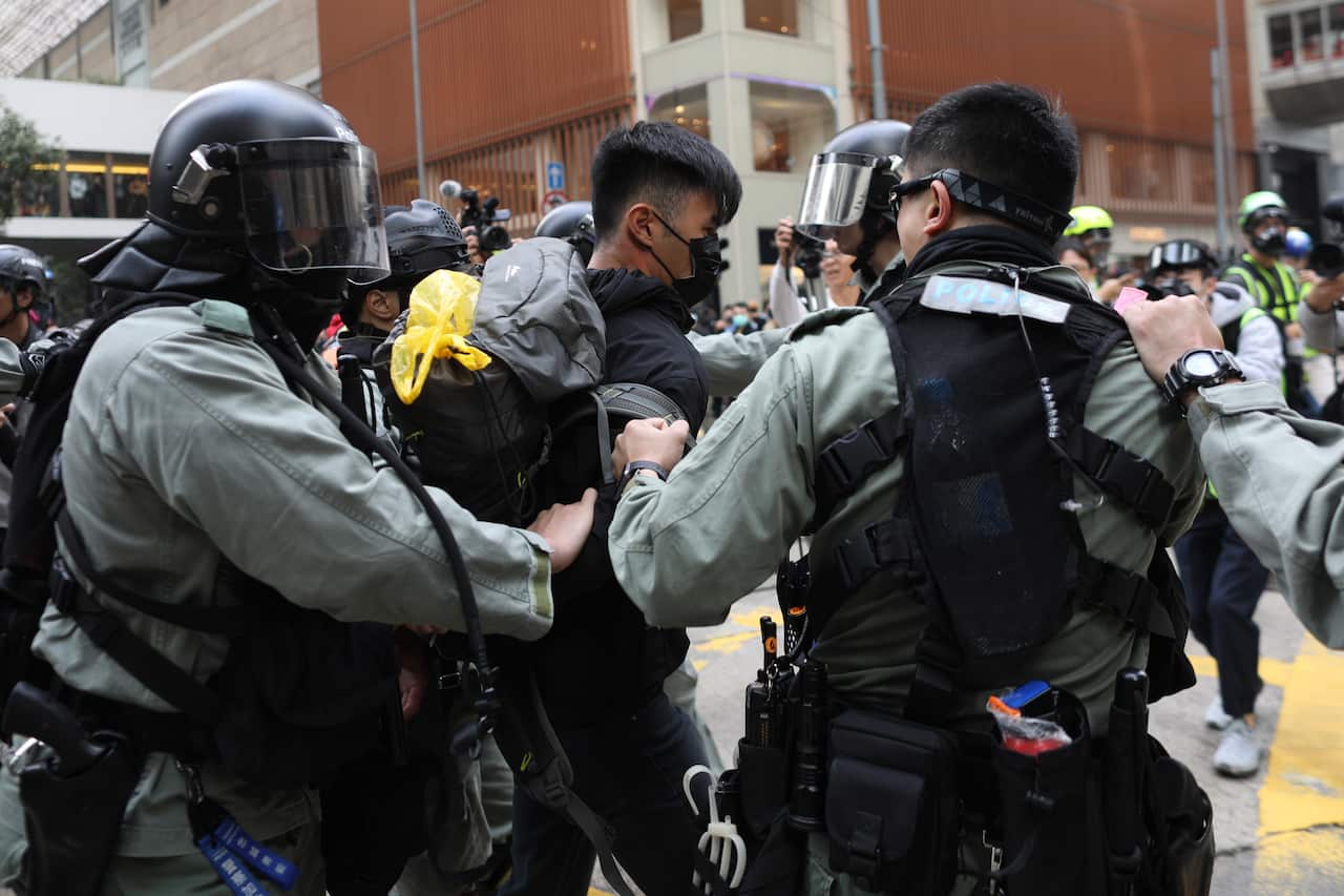 Police remove a demonstrator during a pro-democracy rally against Communism in Hong Kong.