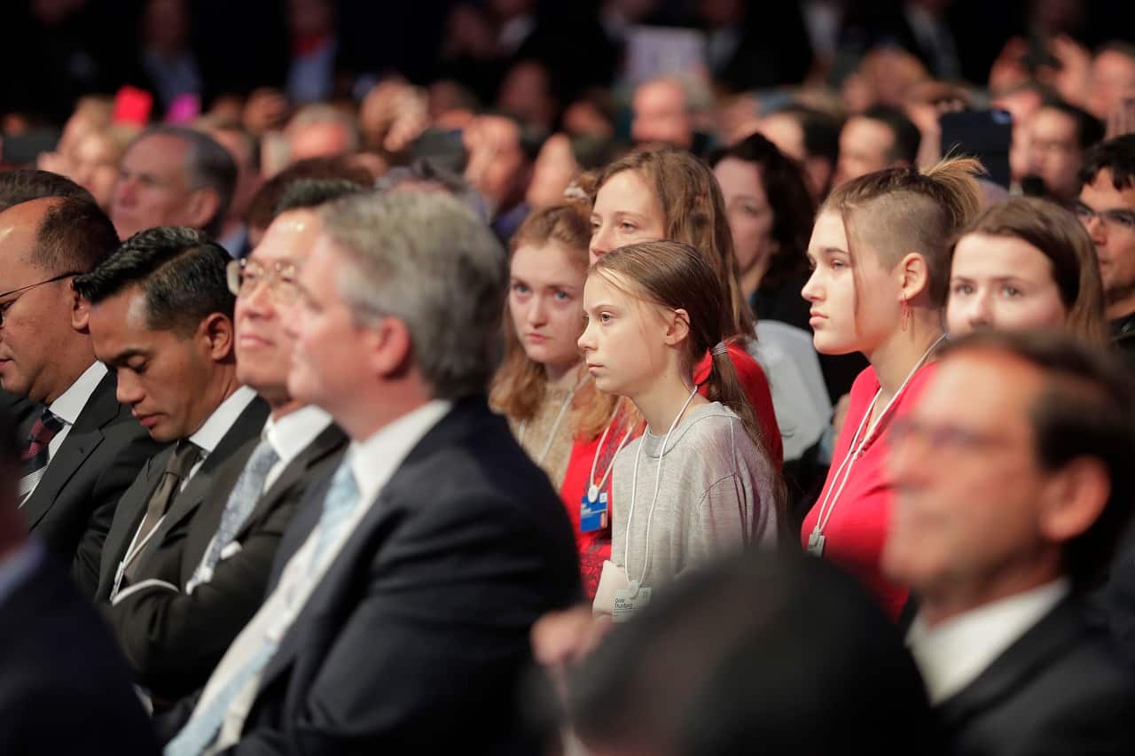 Swedish environmental activist Greta Thunberg listens to Donald Trump.