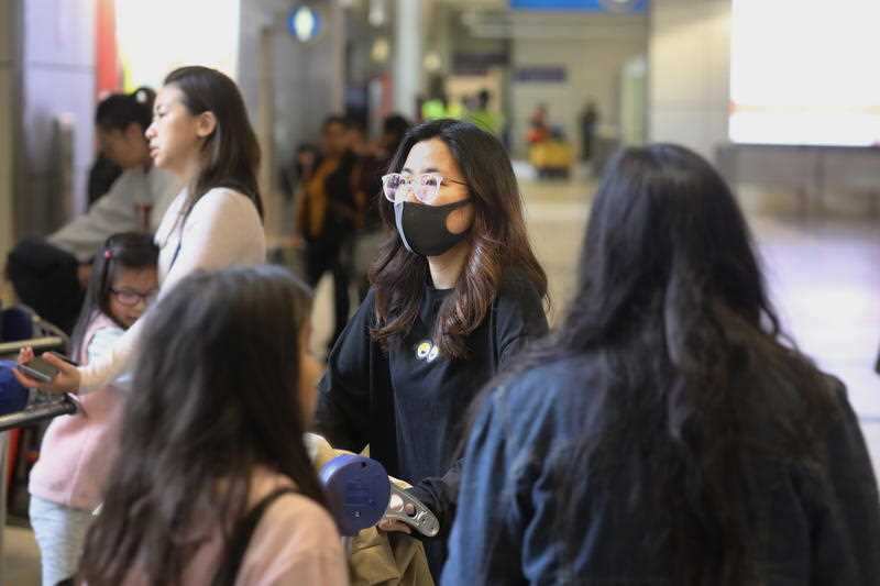 Travelers arrive at Tom Bradey International Terminal in Los Angeles.
