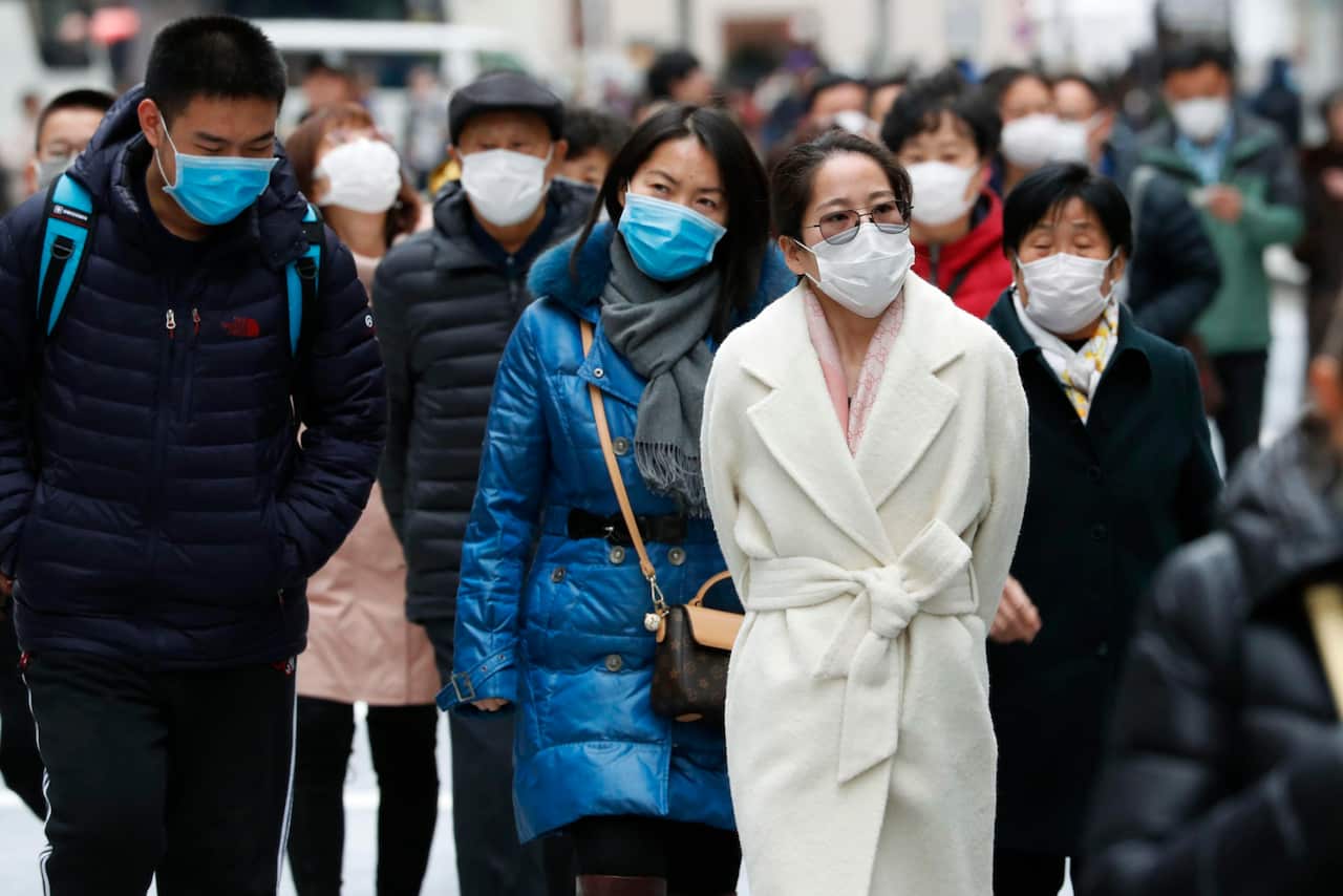 Chinese tourists wear masks in Tokyo amid the spread of pneumonia caused by a new coronavirus in the city of Wuhan