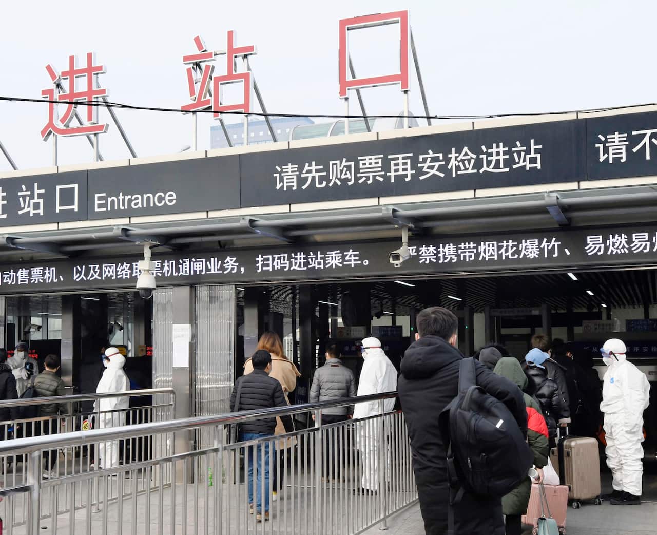 Passengers' body temperatures are checked at a subway station in Beijing on Jan. 26, 2020, amid the spread of pneumonia caused by a new coronavirus in the central Chinese city of Wuhan. (Kyodo via AP Images) ==Kyodo