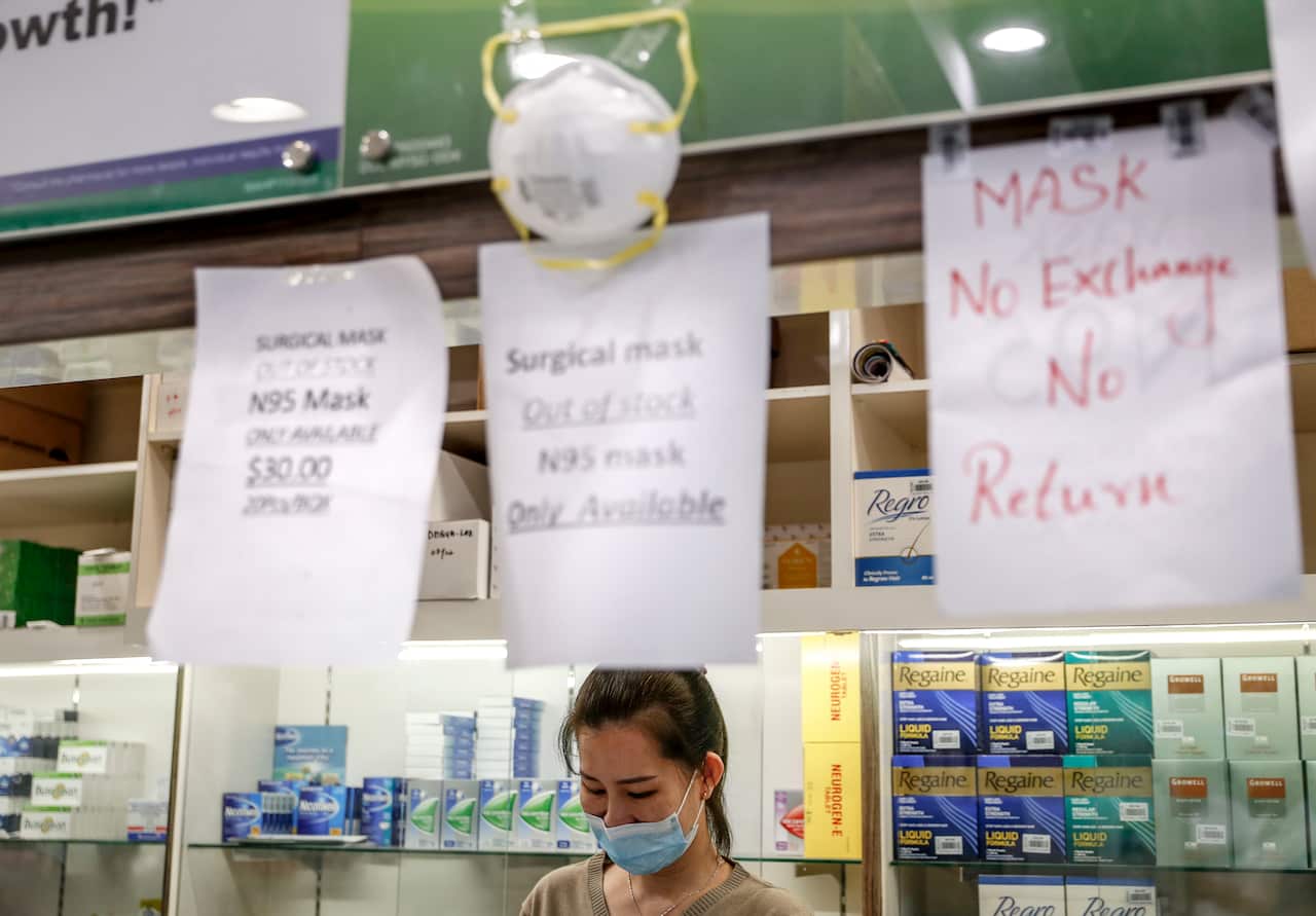 A sign informs customers that surgical masks have sold out at a dispensary in Singapore.