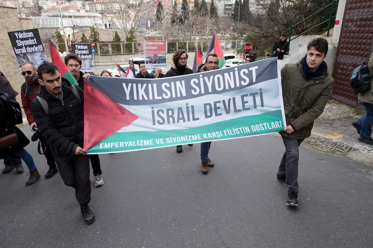 Turkish protesters hold signs reading 'break down the Zionist Israel' during a demonstration against US President Trump's peace plan