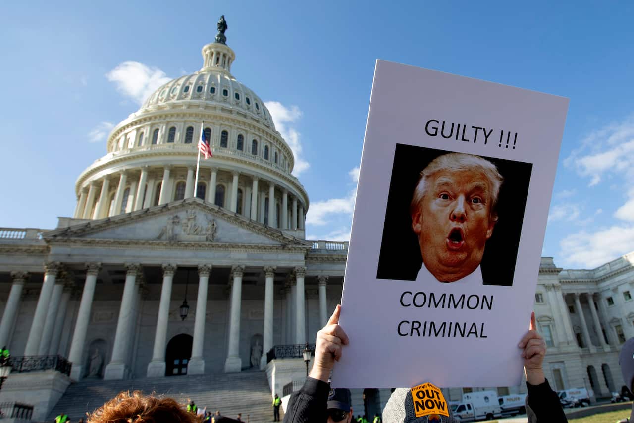 Demonstrators protest outside the US Capitol during the impeachment trial of President Donald Trump