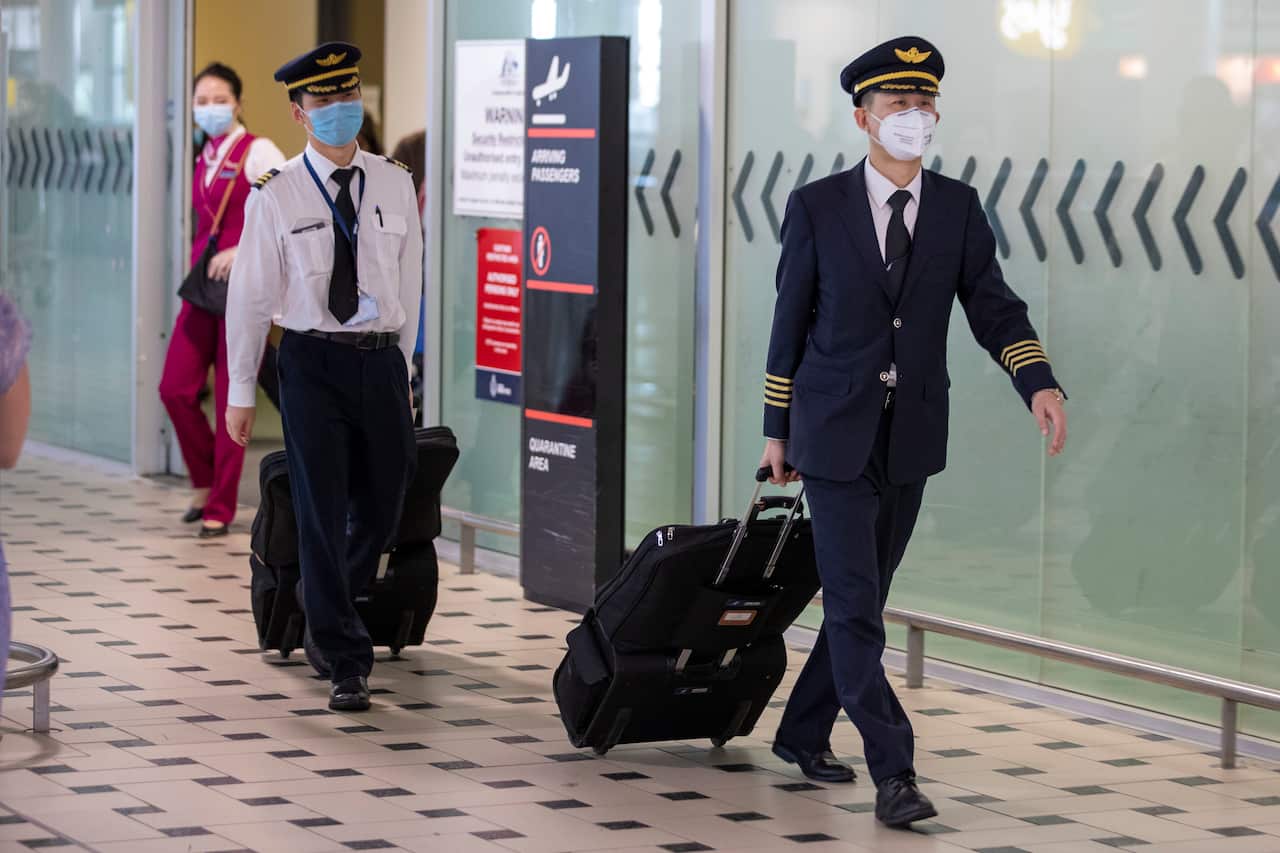 Pilots wearing protective face masks at Brisbane International Airport in Brisbane, Friday, January 31, 2020.