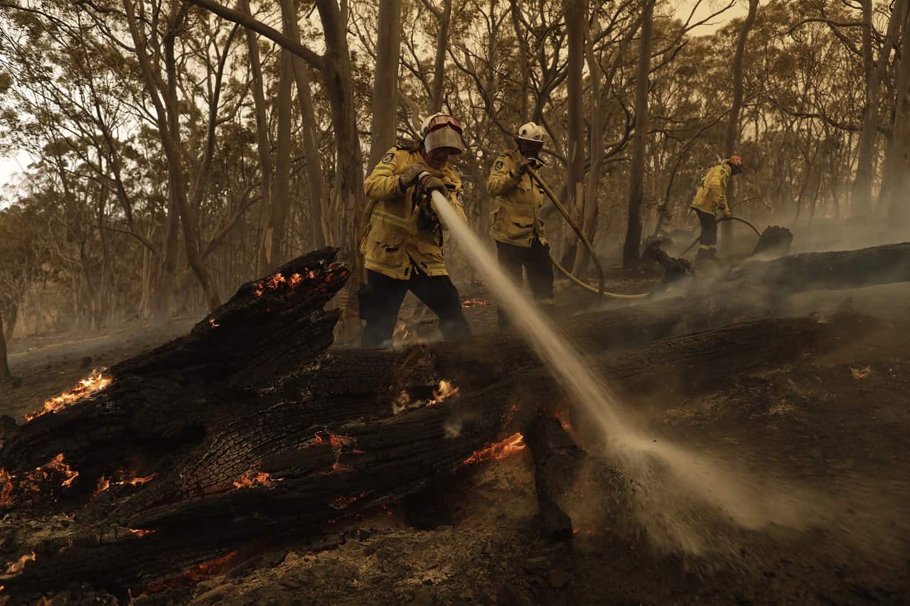 Members of the Sutherland Strike Force RFS contain a spot fire on a property in Colinton earlier this month.