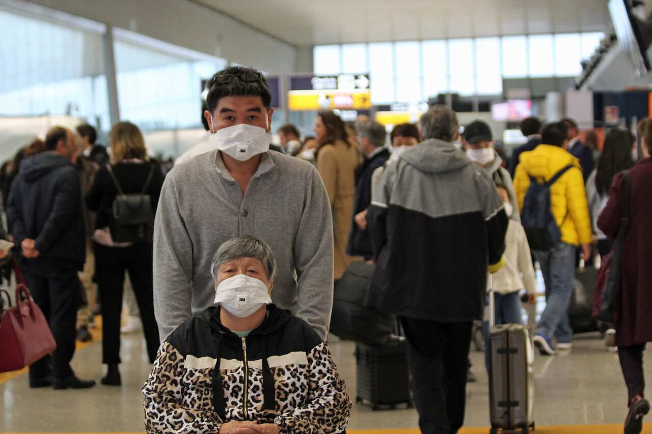 Chinese travelers wearing face masks at 'Leonardo Da Vinci' airport in Fiumicino, near Rome, Italy.