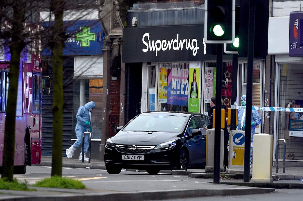 Police forensic officers canvas the scene on Streatham High Road, south London.
