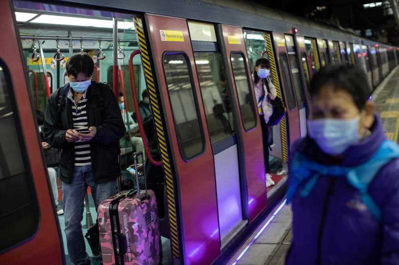 Passengers wear face masks in a Hong Kong bound MTR carriage at Lo Wu MTR station hours before the closing of the Lo Wu border crossing in Hong Kong.